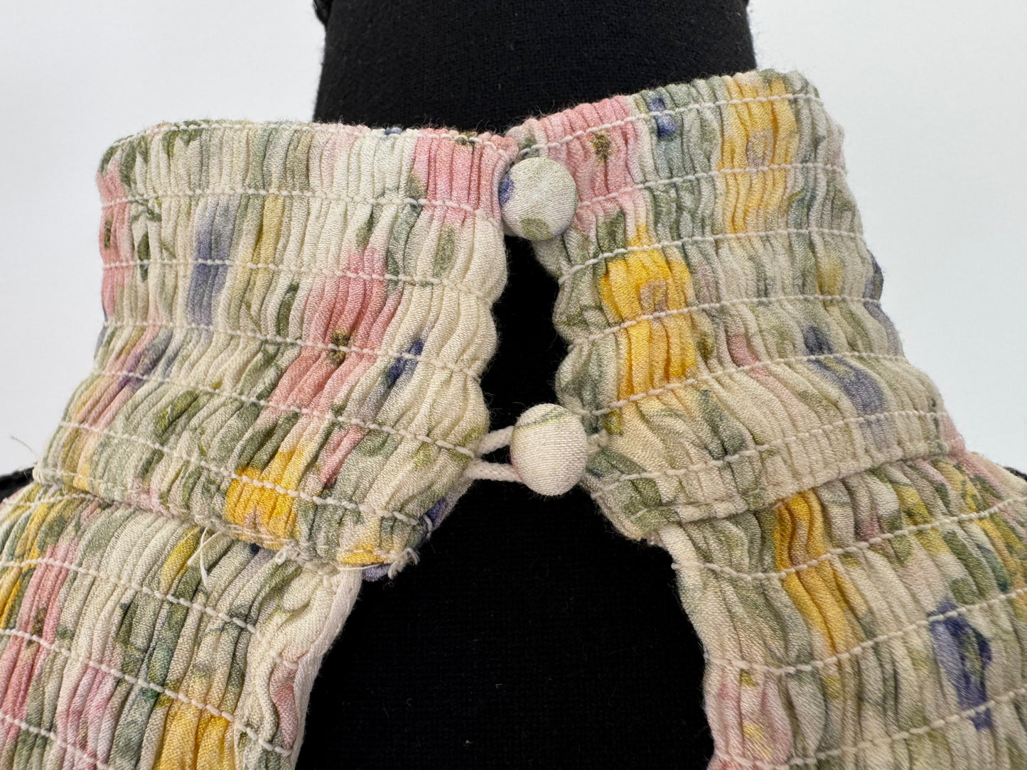 Turtleneck attaches with two buttons in the back of the neck.