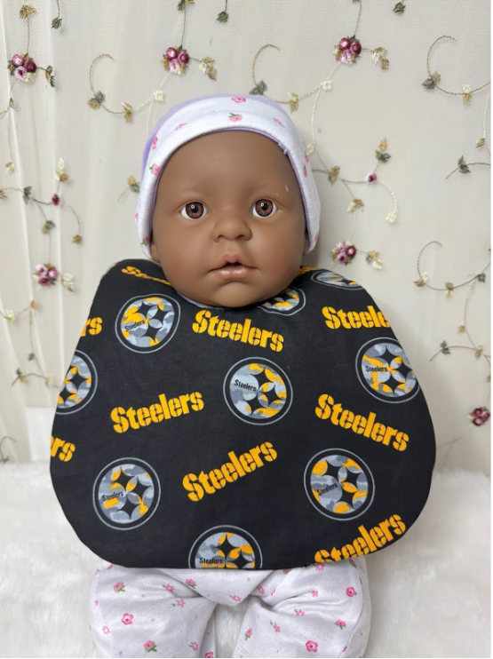 Baby wearing a bib with Steelers logo on a white background