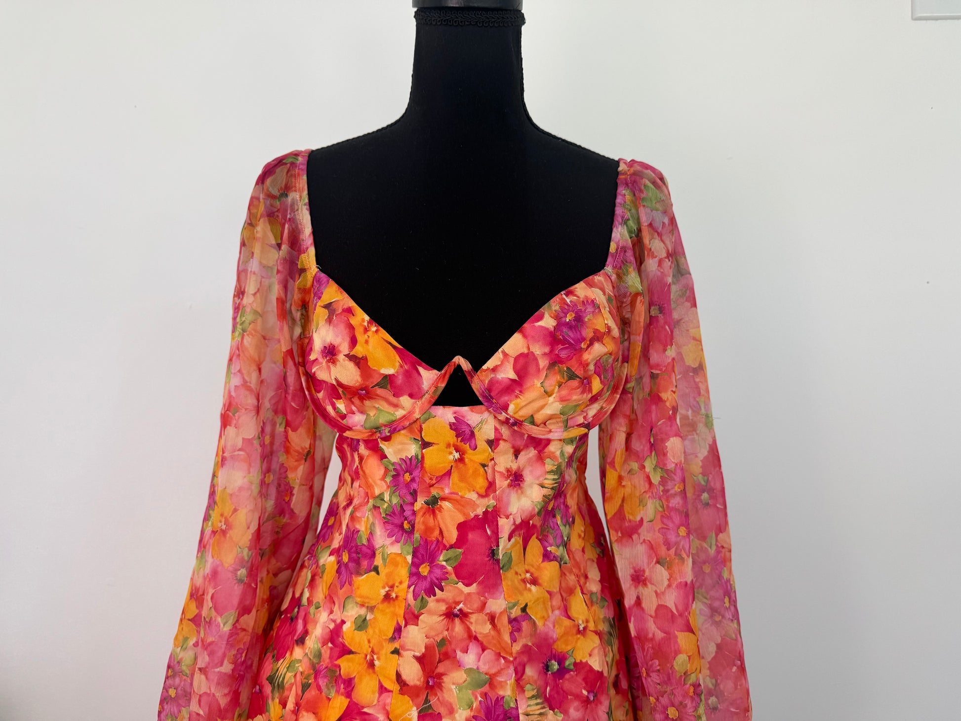 Closer view of front of dress. Close up on the bust hardware design that is perfectly covered with the tropical flower design. Beautiful neckline.