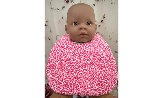 Baby wearing pink leopard print super absorbent bib.