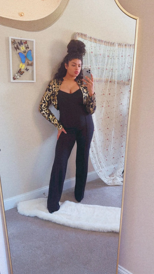 The Girl in the Black and Gold Jumpsuit